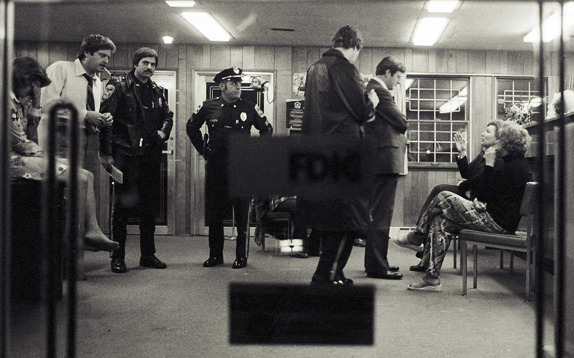 Danbury police and a bank officer interview employees at the City Trust Bank in Danbury after two armed robbers took more than $20,000.  1978