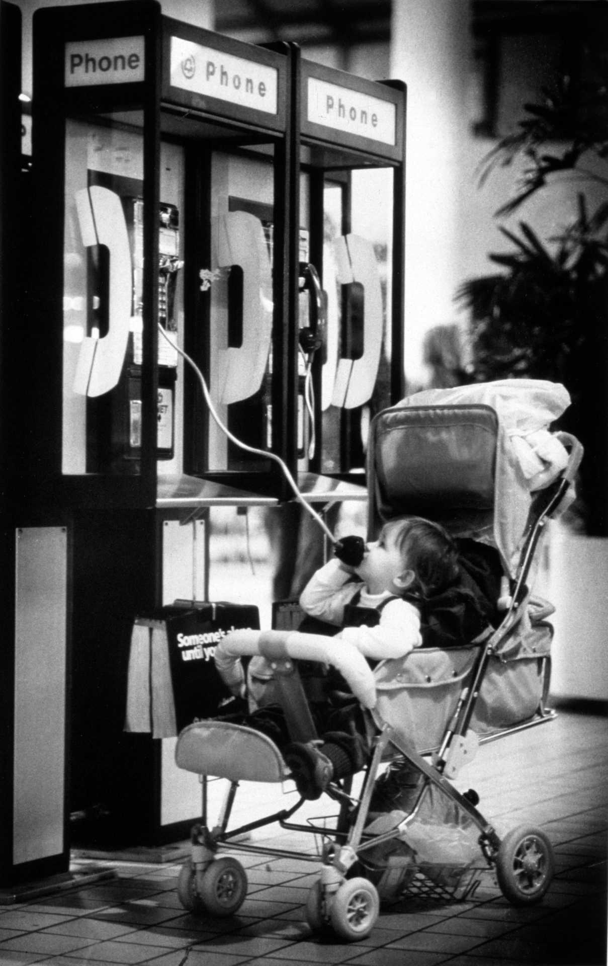  A young child uses the pay phone at the Danbury Fair Mall. 1987