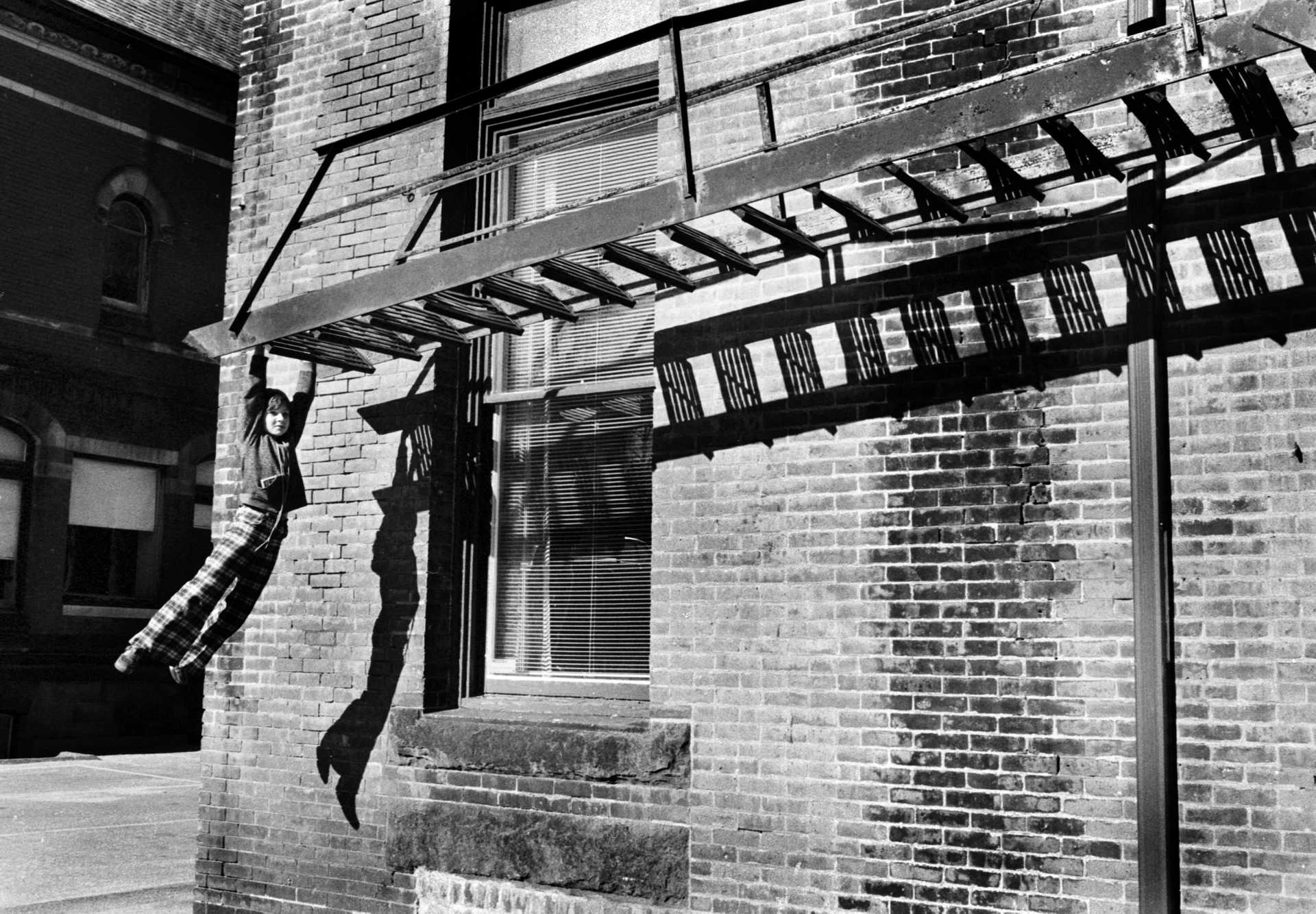 A child swings from a fire escape in downtown Danbury. 1970’s