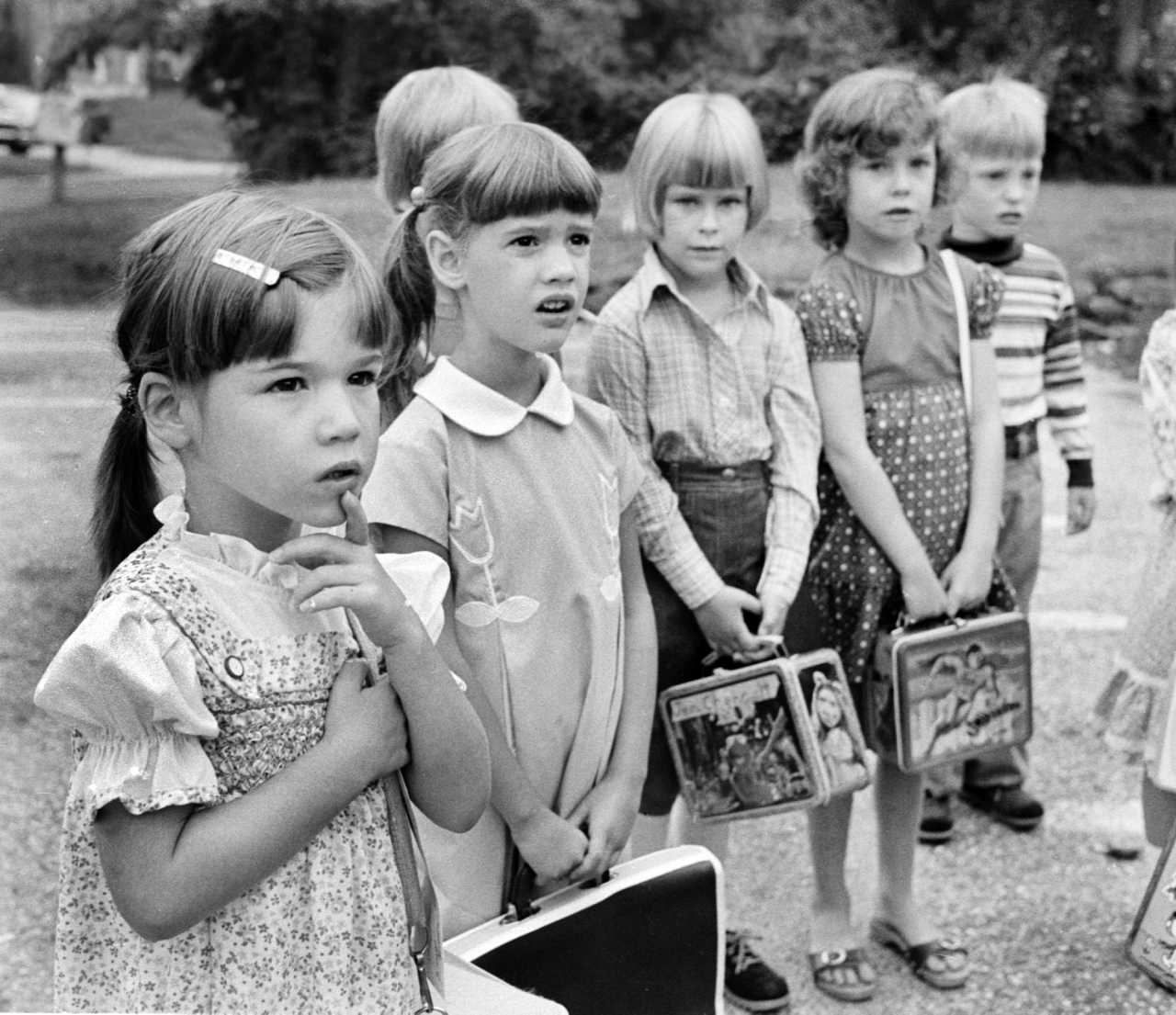 Anxious kindergarteners arrive for the first day of school. 1979