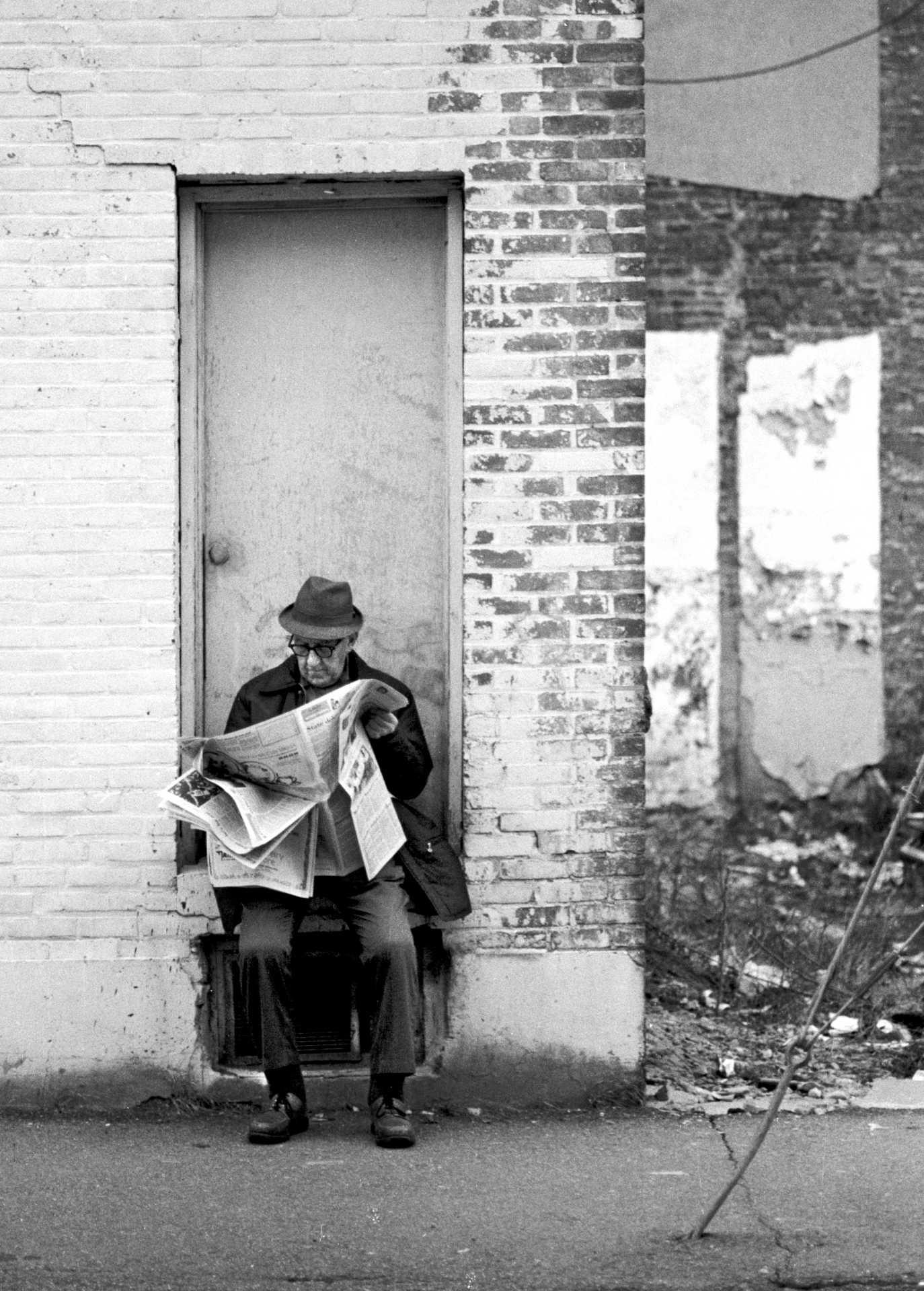 A man catches up on the news in downtown Danbury.  1970’s