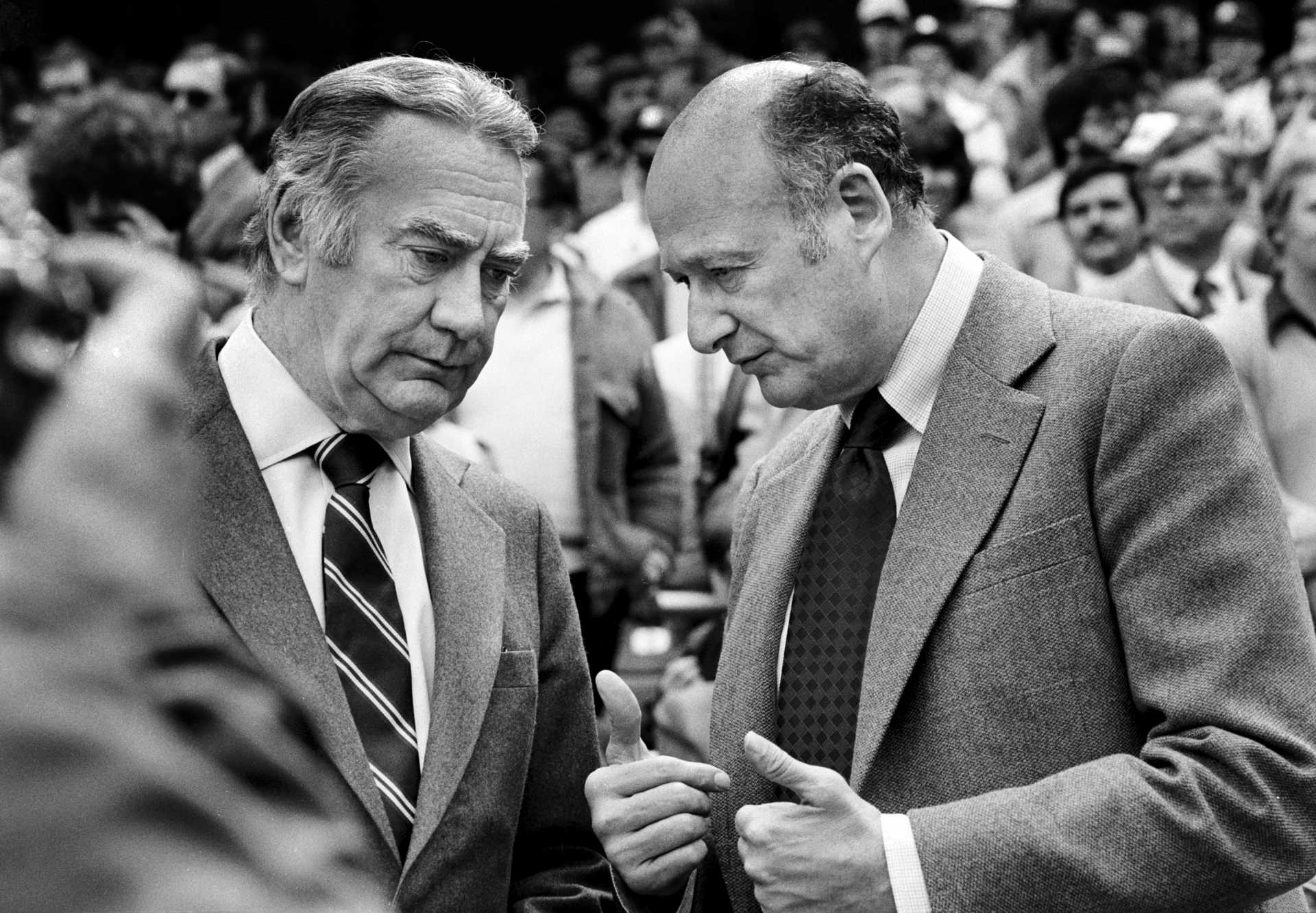 New York Gov. Hugh Carey, left, and New York City Mayor Ed Koch, talk together at the Yankee's season opener at Yankee Stadium. 1980
