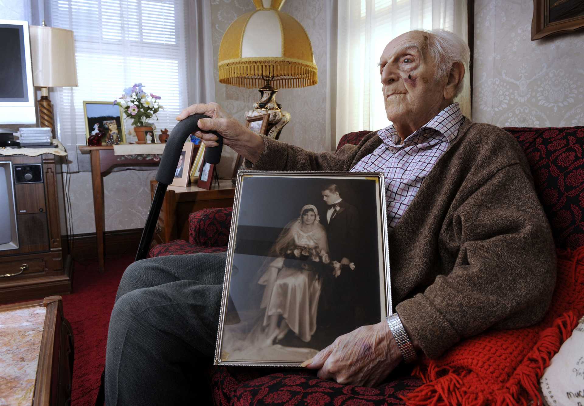 Peter A. Setaro Sr.,105, holds a photograph taken in 1930, the day he married his love, Agnes. 