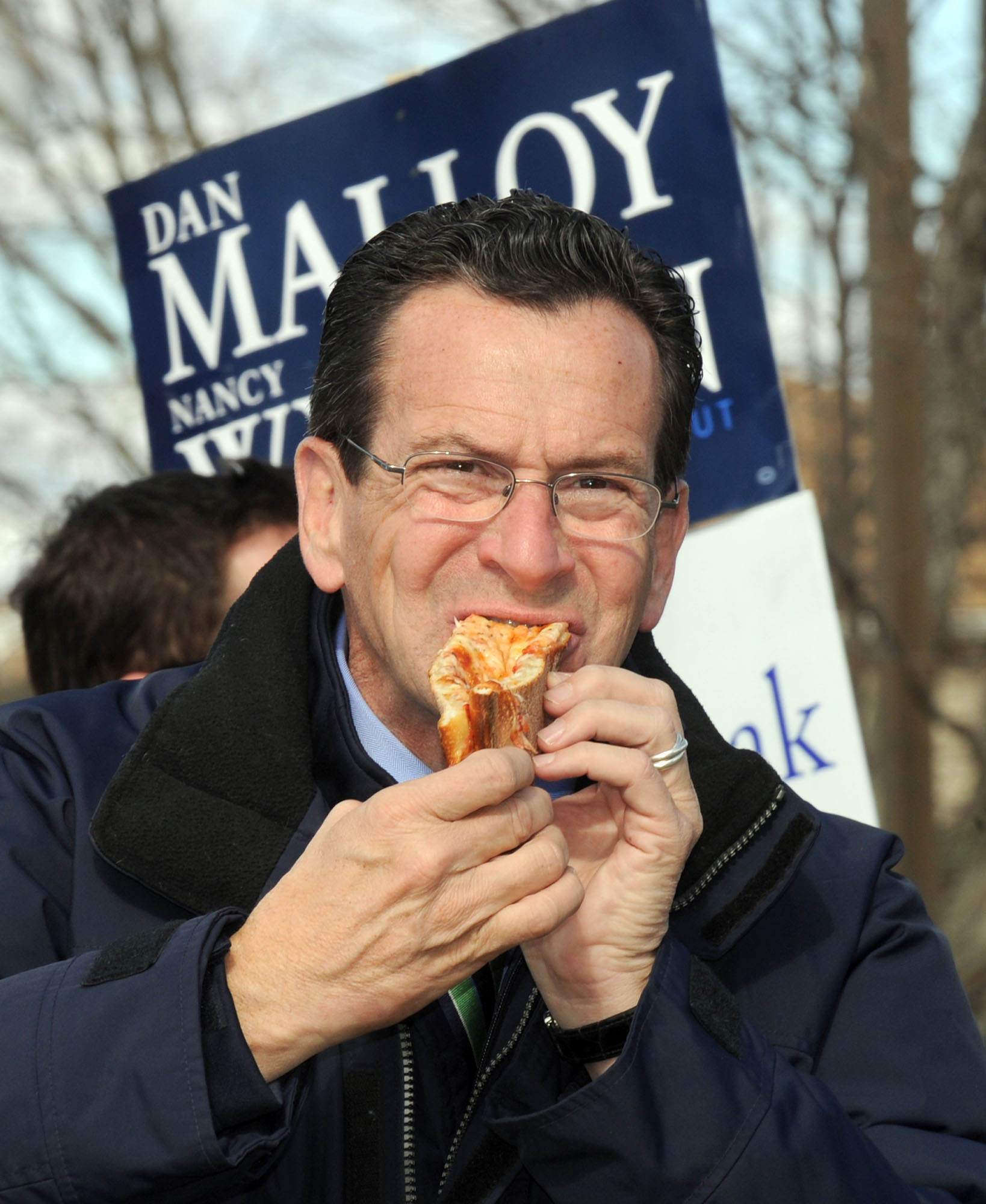 Gov. Dannel Malloy, still just candidate Malloy, grabs a quick slice of pizza during an Election Day stop in Danbury. 